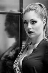 Portrait d'une jolie blonde avec une combinaison fleurie contre un mir de briques