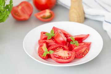 Tomato salad with basil and olive oil in bowl. Selective focus