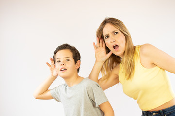 Mother and son making listening gesture