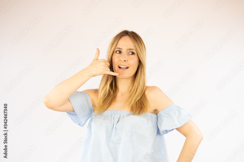 Wall mural woman making the gesture of calling on the phone