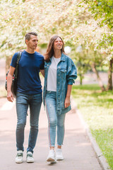 Obraz premium Young beautiful couple having fun in the park on summer day