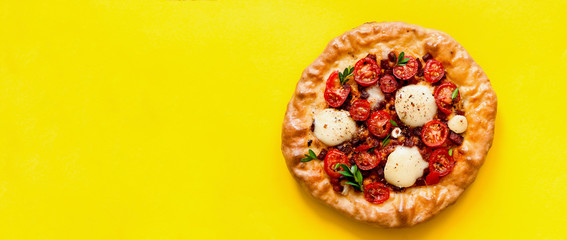 Homemade pizza on yellow background. The concept of traditional Italian food. Stay at home