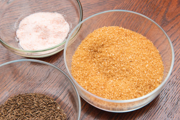 Spices in glass cups. Cane sugar, red sea salt, caraway seeds. home kitchen