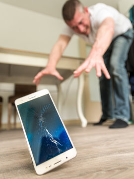Homme ayant fait tomber son smartphone