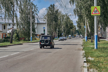 Asphalt road in the city with a old car