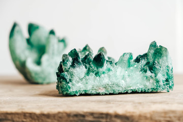 Raw emerald and gemstone rough rock crystal on a wooden table. Copy, empty space for text