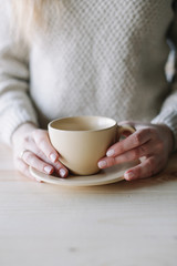 Coffee mug in female hands. girl holding a cup.  Woman drinking hot coffee