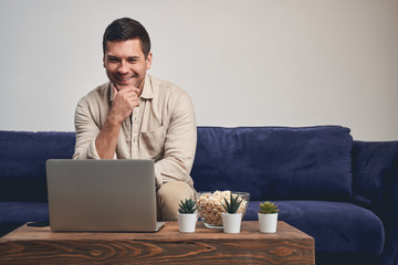 Pleased remote worker looking at the laptop screen