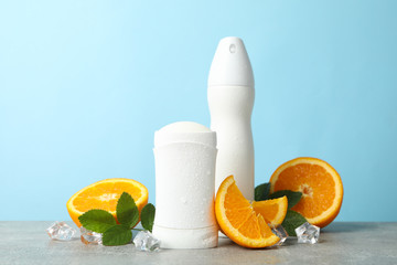Composition with body deodorants on blue background, space for text