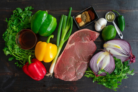 Steak Fajita Skewers With Cilantro Chimichurri Ingredients: Raw Top Sirloin, Bell Peppers, Onions, And Spices Used To Make Grilled Beef And Vegetable Kebabs