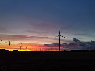 Silhouette of windturbines on an amazing sunset.