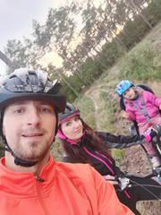 happy family riding bike in a park.