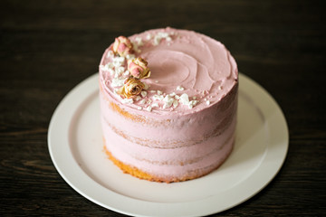 Pink cake with berry stuff on a white dish. 
