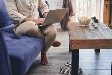 Man under quarantine working on his laptop from home