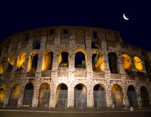 Fototapeta na wymiar Ruins of the ancient Colosseum on a moonlit night, Rome, Italy