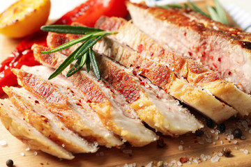 Chopped fried steak with spices on wooden background, close up