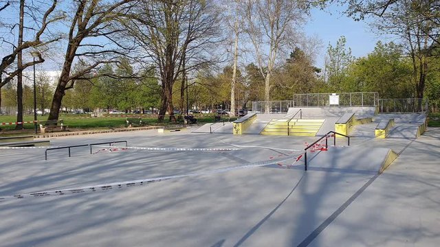 LJUBLJANA, SLOVENIA, APRIL 2020: Skateboard and BMX park is closed to keep people from gathering in public spaces during covid-19 outbreak. Tape prevents youth from skateboarding during quarantine