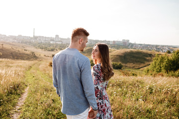 happy loving couple on the mountain. Happy couple faces skyline at city. Top view point overlooking the mountains. holidays, vacation, love and friendship concept