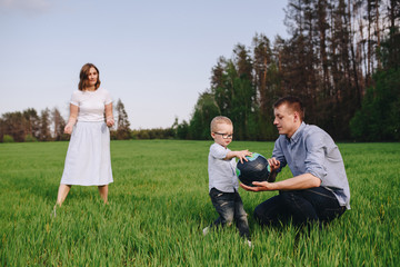 Family in the forest for a walk. Picnic in the meadow, on the gr