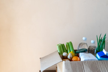 Box with products on a light background. Home delivery concept.