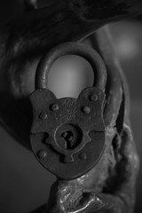 Big old padlock close-up. Black and white photo