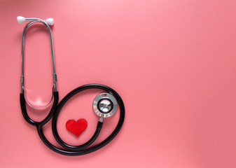 International's nurse day, week concept, stethoscope and red heart on pink background with copy space. Space for text.