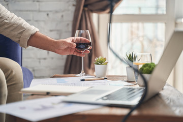 Caucasian man with a wineglass sitting indoors