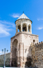 Fototapeta na wymiar Bell tower at the entrance to the courtyard of Svetitskhoveli Church. Georgia