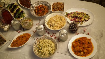 Dining Christmas table preparing dinner. Serving homemade food family home. Festive decor candles, pine. Top view.
