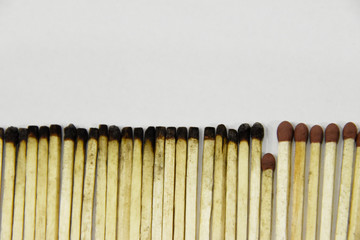 Matches new and burnt, with one saving others, symbolizing virus pandemic.