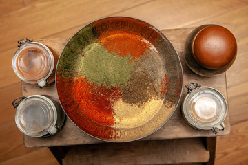 Ground spices in a bowl with bay leaf