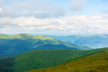 Fototapeta premium alpine scenery of carpathian mountains. stunning views on a windy summer day. clouds on the sky. ridges and valleys in the distance