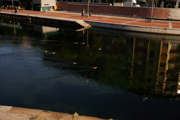 Obraz premium Porta Ticinese quarter in Milan town center reflecting in Darsena del Naviglio canal. City area popular by tourists.