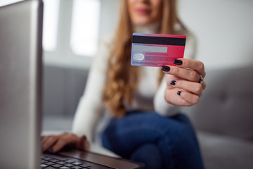 Blonde woman using credit card to buy online