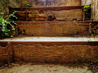 Old steps close up. Staircase of an abandoned building overgrown with grass.
