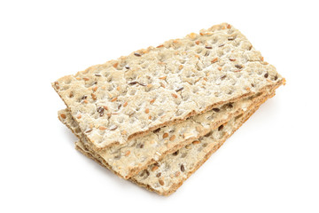 Stack of wholegrain dry crispy bread isolated on a white background in close-up