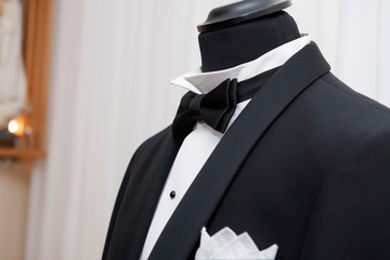 groom hand and black bow tie