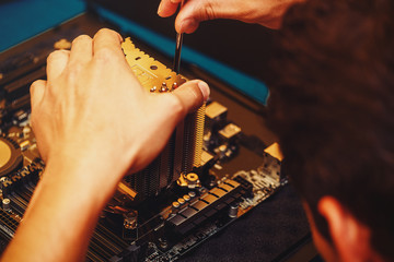 Repairman repairs the computer, Removing the computer motherboard.