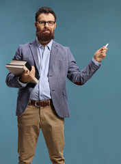 Male teacher holding books and a chalk