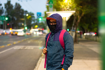 Young man wears a protective face mask on the street