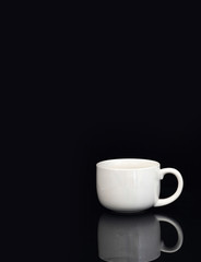 white coffee cup on black