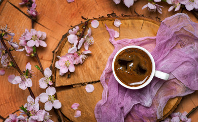 cup of coffee with flowering tree branches