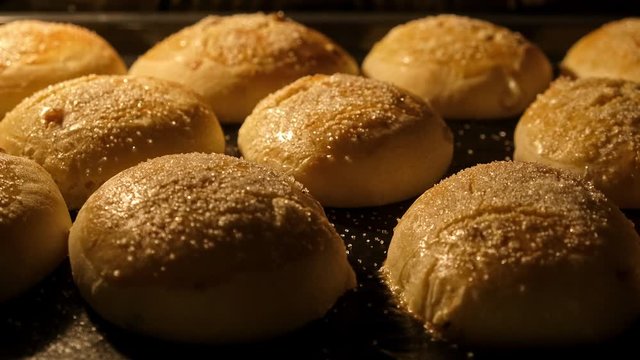 Buns backed in oven. Baking of baked goods and growth oven. Timelapse of delicious homemade buns baked. Baking concept