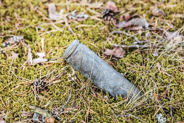 an old used large caliber cartridge case is sticking out of the ground