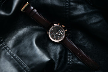 Gold LEATHER WATCH, VINTAGE STYLE WRIST WATCH, MEN'S LEATHER WATCH on leather background blur.