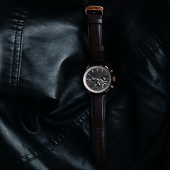 Gold LEATHER WATCH, VINTAGE STYLE WRIST WATCH, MEN'S LEATHER WATCH on leather background blur.