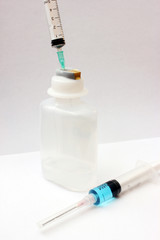 syringes with medicine bottle on white background