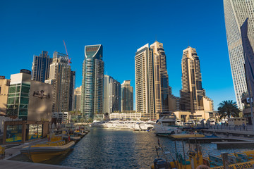 Fototapeta na wymiar Dubai, UAE. Year 2019: Modern Arab style architecture buildings in Marina Dubai. Exclusive neighborhood, residence, coportarivo and tourist. Rich lifestyle. Yachts in the water. Real estate business