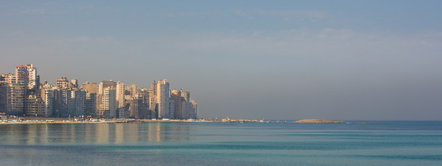Mediterranean coast at Miami district, Alexandria city, Egypy, with very tall buildings by the seaside at a sunny summer day