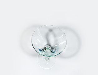 top view of martini glass on white with shadows